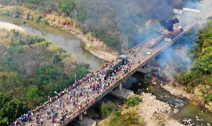 Testemunhas afirmaram que grupos violentos da oposição venezuelana incendiaram os caminhões com bombas Molotov e tentaram culpar a Guarda Nacional Bolivariana